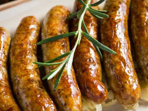 Juicy,grilled,sausages,with,cabbage,salad,,mustard,and,beer