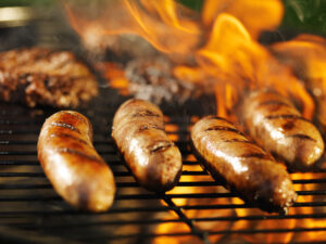 Bratwursts,cooking,on,flaming,grill